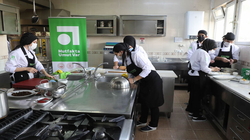 Turkish and Syrian students prepare food in a kitchen,. as part of the "Mutfakta Umut Var - Hope in the Kitchen" project attended by Turkish and Syrian youths, Ankara, Turkey, Oct. 8, 2020.