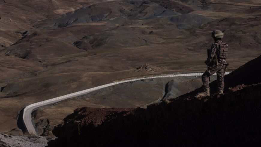 A Turkish Special Forces Police officer is seen standing watch during a press tour at a border outpost.