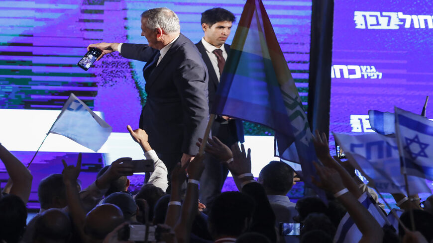 Retired Israeli Gen. Benny Gantz, one of the leaders of the Blue and White party, uses a cellphone to take a selfie photograph with supporters during a campaign event, Tel Aviv, Israel, April 7, 2019.