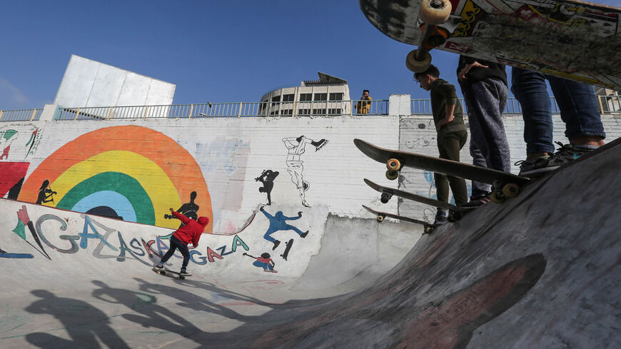 Palestinian youths ride their skateboards near the sea port of Gaza City, Gaza Strip, March 20, 2019.