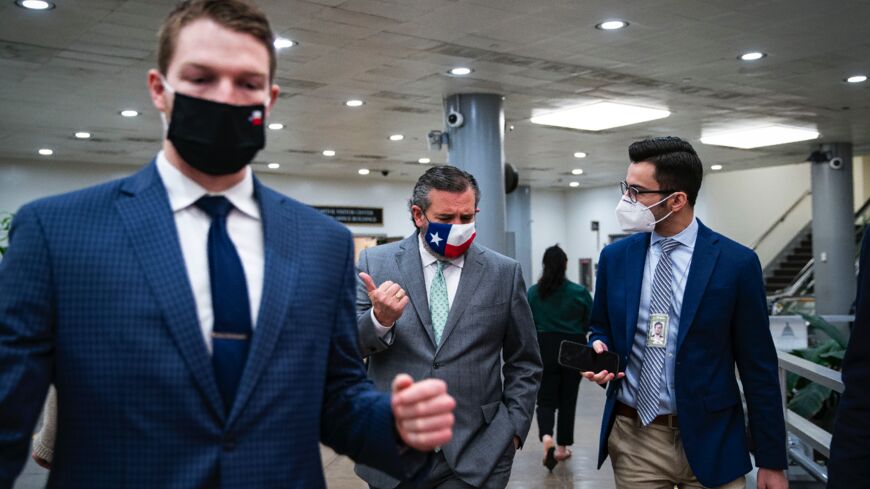 Sen. Ted Cruz (R-TX) (C) speaks with a reporter following a vote as he departs in the subway of the US Capitol on February 23, 2021, in Washington, DC. 