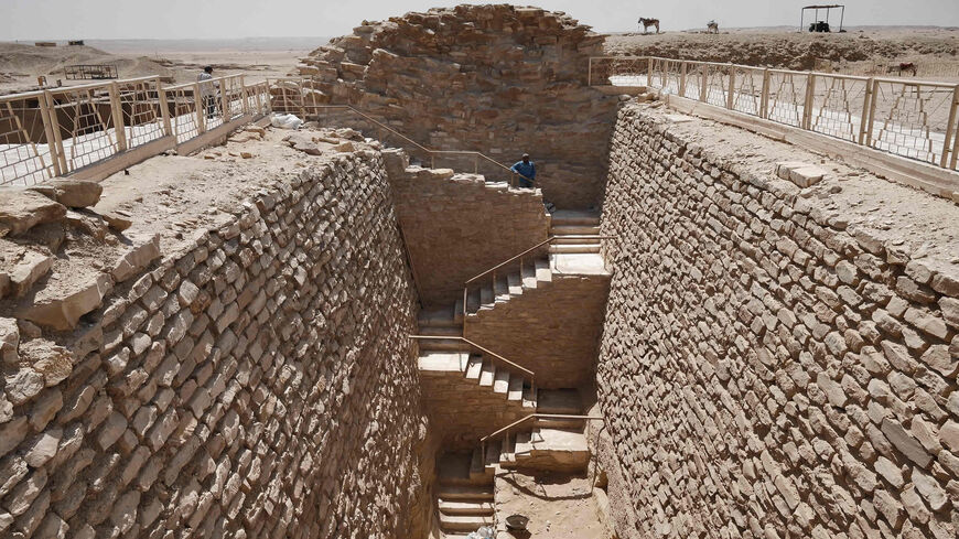 A workman stands along the steps leading to the southern tomb near the step pyramid of the third dynasty Pharaoh Djoser (27th century B.C.), at at the Saqqara Necropolis, Egypt, May 27, 2021.