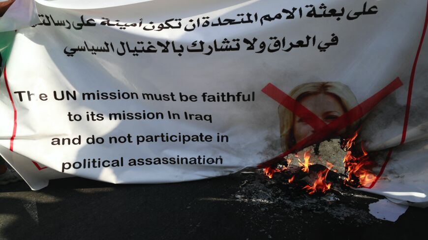 Supporters of the pro-Iran Hashid al-Shaabi alliance burn a banner bearing a crossed portrait of the special representative of the UN secretary-general's Assistance Mission for Iraq Jeanine Hennis-Plasschaert.