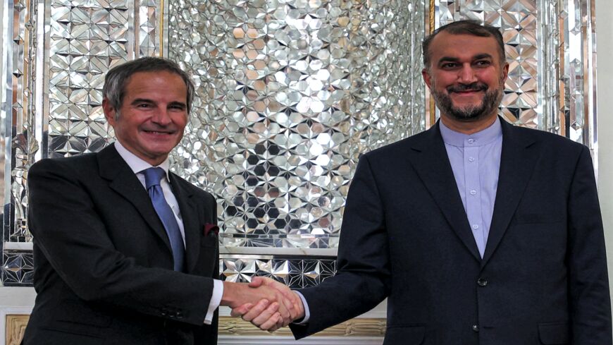 (R to L) Iran's Foreign Minister Hossein Amir-Abdollahian shakes hands with Director-General of the International Atomic Energy Agency (IAEA) Rafael Grossi.