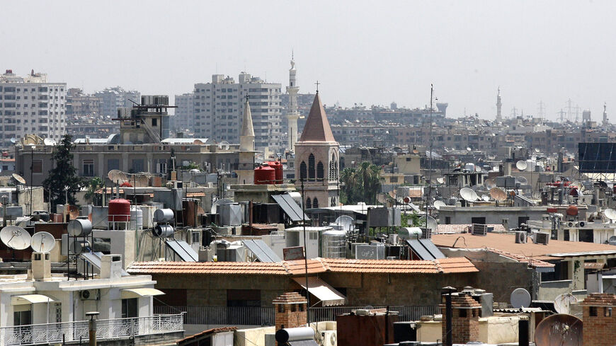 The minarets of mosques and the steeples of churches are seen towering above rooftops in the Syrian capital Damascus, on June 26, 2013. 