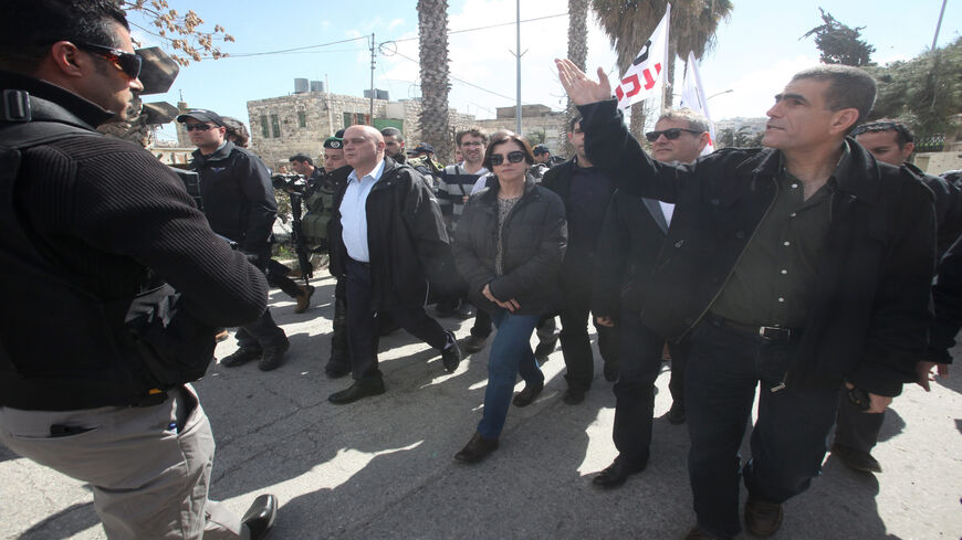 Israeli Meretz party members Nitzan Horowitz (2nd R), Zehava Galon (C) and Issawi Frej (C-L) take part in a visit of al-Shuhada street in support of Palestinians who were forced out of the old quarter at the outset of the second Palestinian intifada by the Israeli army to allow for Jewish settlers to move securely in the area, Hebron, West Bank, Feb. 25, 2014.