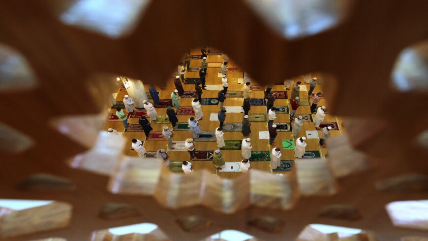 Muslim devotees pray on the first Friday of the holy fasting month of Ramadan at a mosque in Dubai on April 16, 2021.