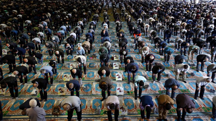 Mask-clad Iranians gather in a mosque in the capital, Tehran, on Oct. 22, 2021.