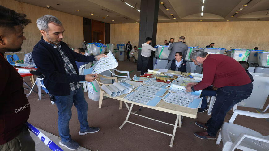 Employees of the Independent High Electoral Commission conduct a partial manual recount of votes for the Oct. 10 parliamentary elections, Baghdad, Iraq, Nov. 23, 2021.