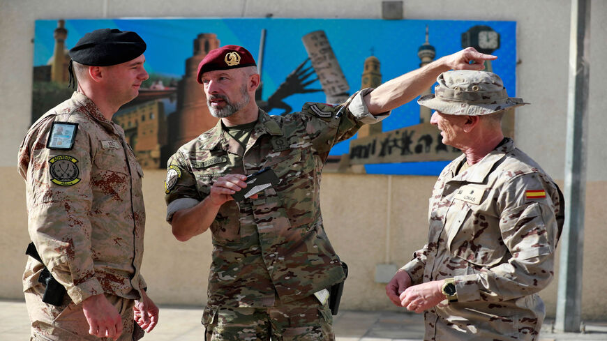 Officers of the US-led international coalition against the Islamic State stand outside the Joint Operations Center in the Green Zone, Baghdad, Iraq, Dec. 9, 2021.