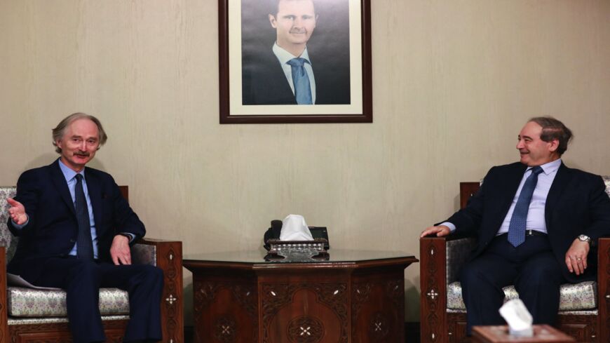 Syrian Foreign Minister Faisal Miqdad (R) receives the United Nations Special Envoy for Syria Geir Pedersen (L) in the capital Damascus, on Dec. 12, 2021.