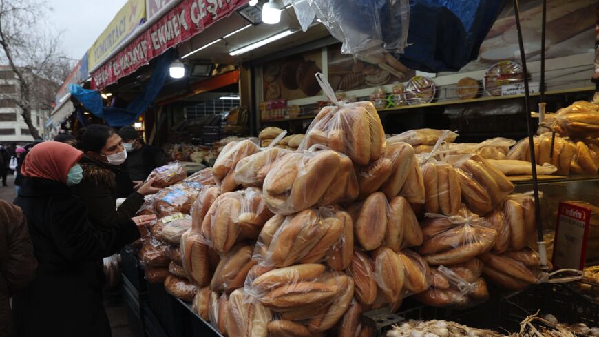 Women shop bread at a market in Ankara on Dec. 20, 2021.