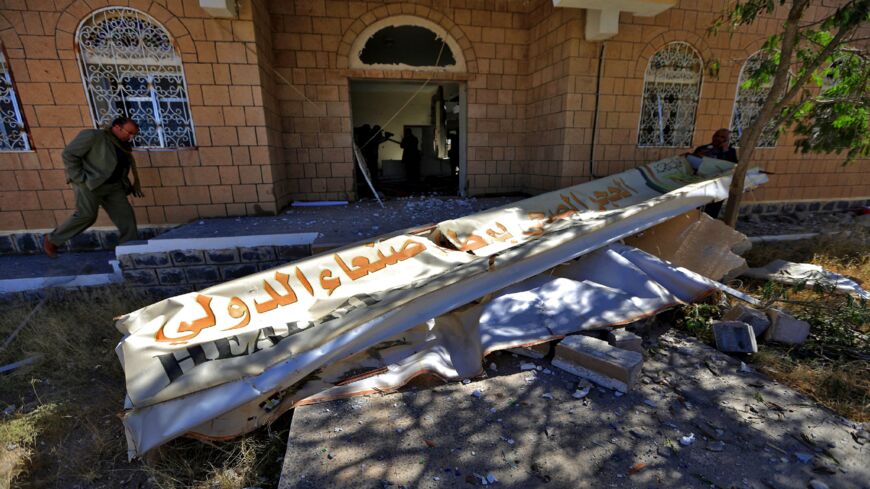 Airport workers inspect the damage at Sanaa International Airport on Dec. 21, 2021, following a reported airstrike by the Saudi-led coalition.