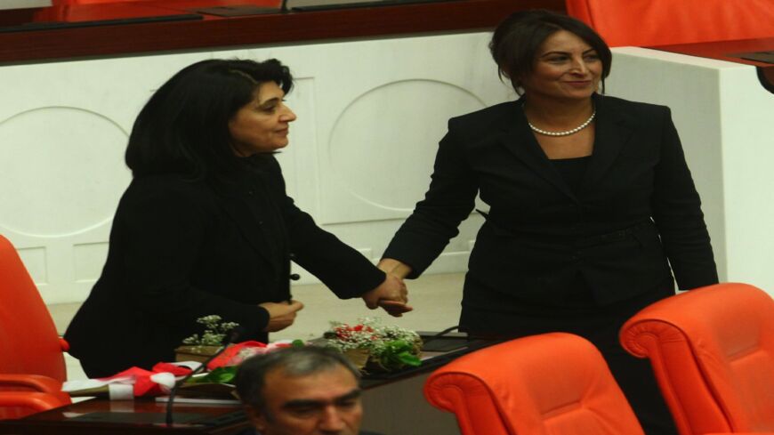 Pro-Kurdish lawmaker Leyla Zana is embraced by lawmaker Aysel Tugluk (R) as she arrives at the parliament in Ankara on Oct. 1, 2011. 