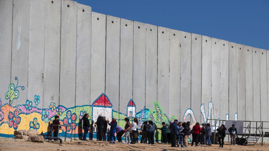 Israeli tourists take pictures near the border between Israel and the Gaza Strip on Feb. 7, 2017. 