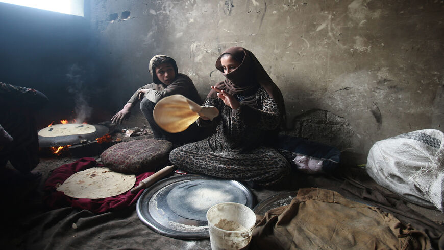 Syrians cook bread inside a school turned into a shelter for people displaced by the war, in the rebel-controlled town of Hamouria, in the eastern Ghouta region, Syria, Dec. 23, 2017. 