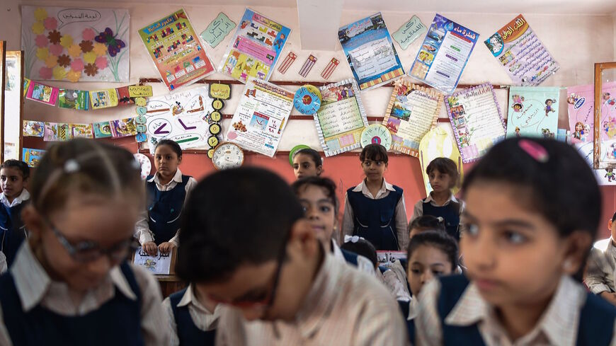 Pupils attend a class at the Mahaba school in Ezbet al-Nakhl, a shanty town north of the Egyptian capital Cairo, on Oct. 13, 2018. 