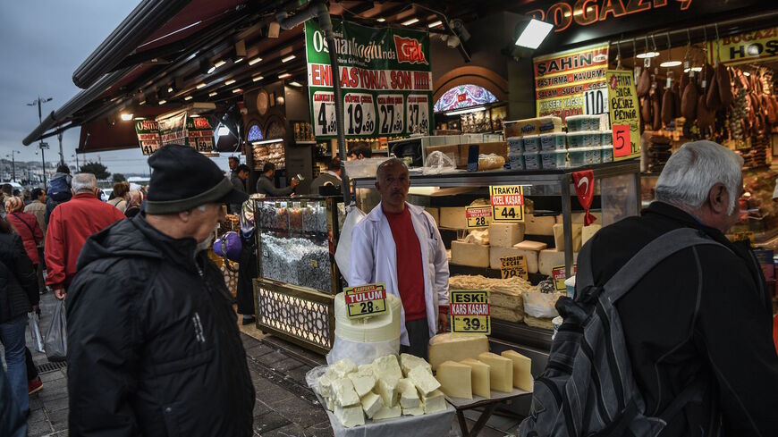 Vendors sell cheese as people shop near the New Mosque area in Istanbul's Eminonu district on Nov. 6, 2018. 