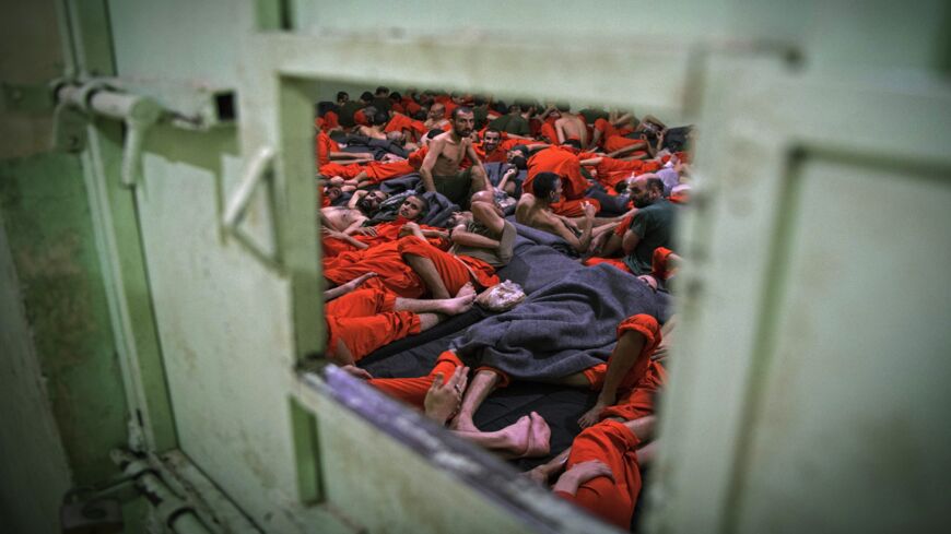 Men suspected of being affiliated with the Islamic State gather in a prison cell in the northeastern Syrian city of Hasakeh on Oct. 26, 2019. 