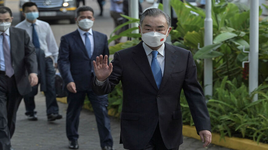 China's Foreign Minister Wang Yi waves as he arrives at the Sarova Whitesands Hotel for a bilateral meeting with Kenyan officials led by his Kenyan counterpart, Raychelle Omamo, Mombasa, Kenya, Jan. 6, 2022.