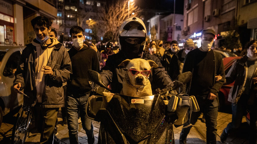 A protester rides a motorbike with his dog during a protest against the appointment of new Bogazici University rector Melih Bulu in the Kadikoy district on Feb. 2, 2021 in Istanbul Turkey. 