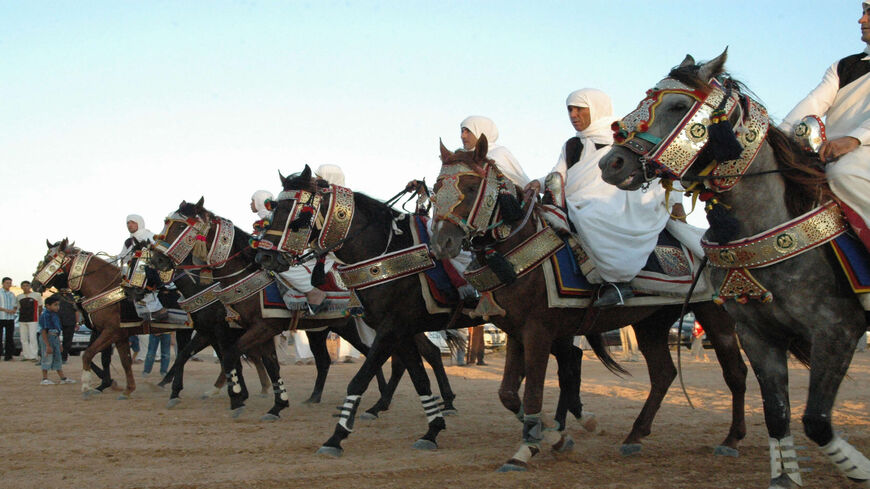 Libyan men in traditional outfits arrive on their horses during a group wedding ceremony held in the western port city of Misurata, Libya, Sept. 5, 2006.