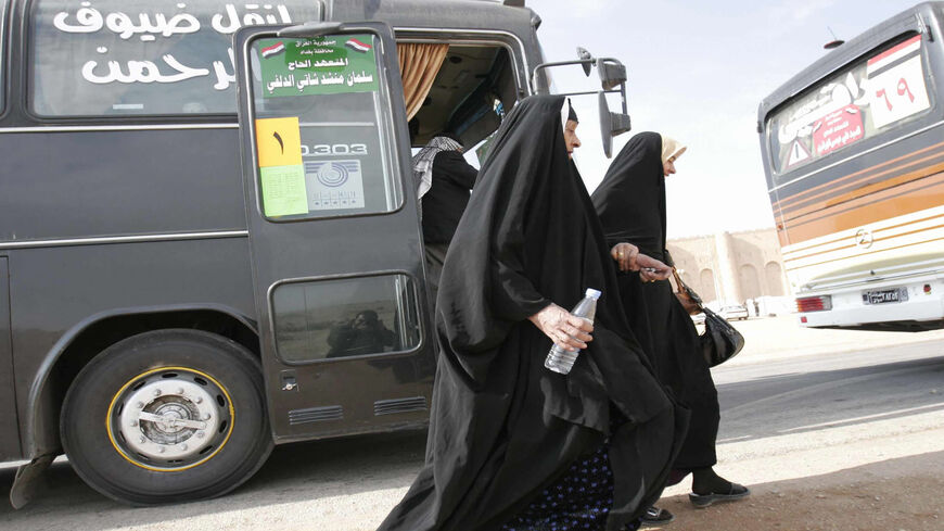 Iraqi women ready to board a coach, part of a convoy, heading south of the Iraqi city of Karbala some 120 kilometers (74 miles) from the capital Baghdad, toward the Saudi Arabian city of Mecca, Nov. 22, 2008.