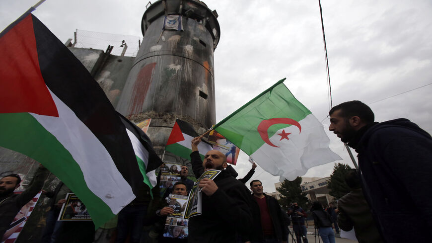 Palestinian protesters chant slogans and wave the national flag and the Algerian flag during a demonstration in Bethlehem, following the weekly Muslim Friday prayers, West Bank, Dec. 29, 2017.