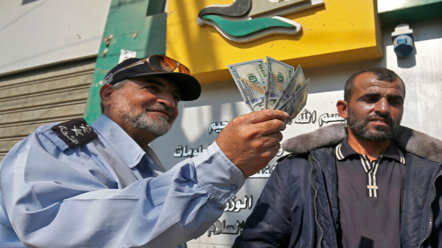 A Palestinian man receives his salary, Rafah, Gaza Strip, Nov. 9, 2018.