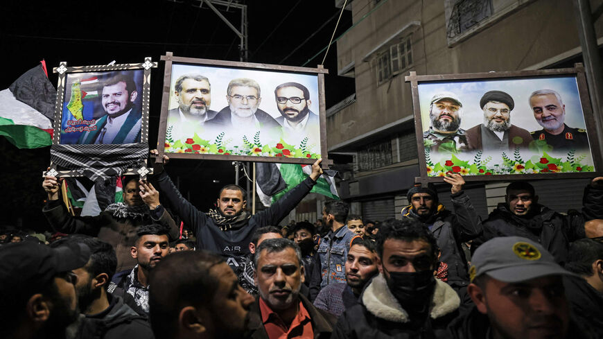 Palestinian Islamic Jihad supporters lift placards as they demonstrate to denounce the war in Yemen, Gaza City, Gaza Strip, Jan. 22, 2022.