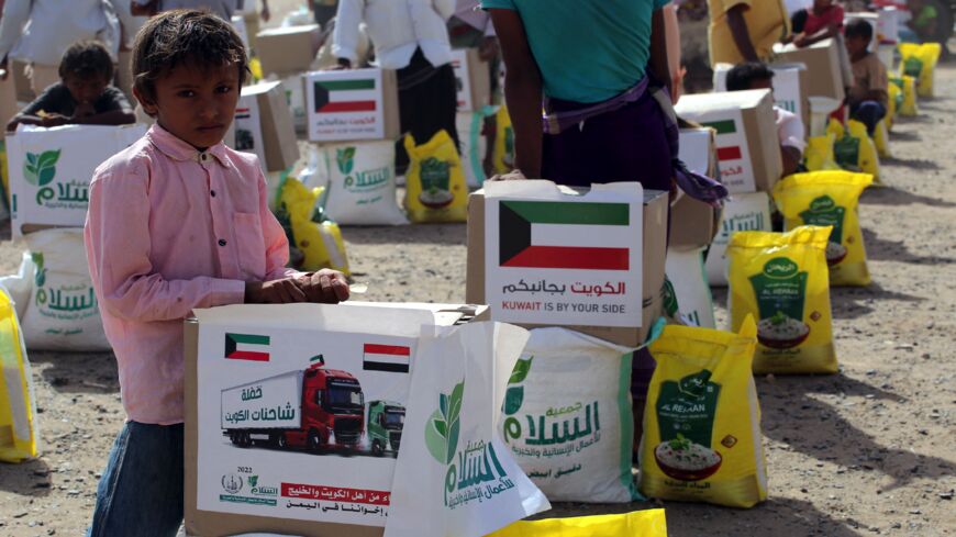 Yemenis displaced by conflict receive provisions to meet basic needs at a camp in Khokha district on Jan. 31, 2022.