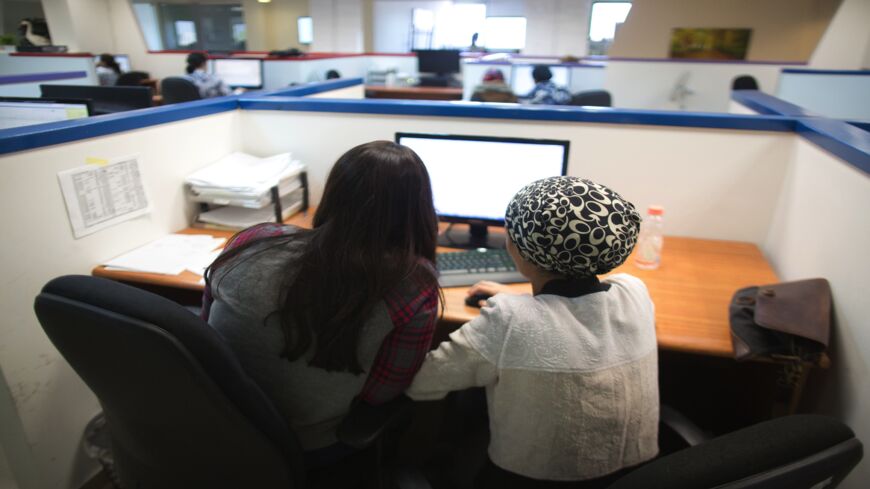 Ultra-Orthodox Jewish women work on computers in the central city of Holon on April 17, 2016. 