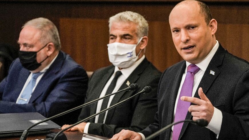 Israeli Prime Minister Naftali Bennett, on the right, chairs the weekly cabinet meeting, with Foreign Minister Yair Lapid to his left and Finance Minister Avigdor Lieberman, on February 20, 2022