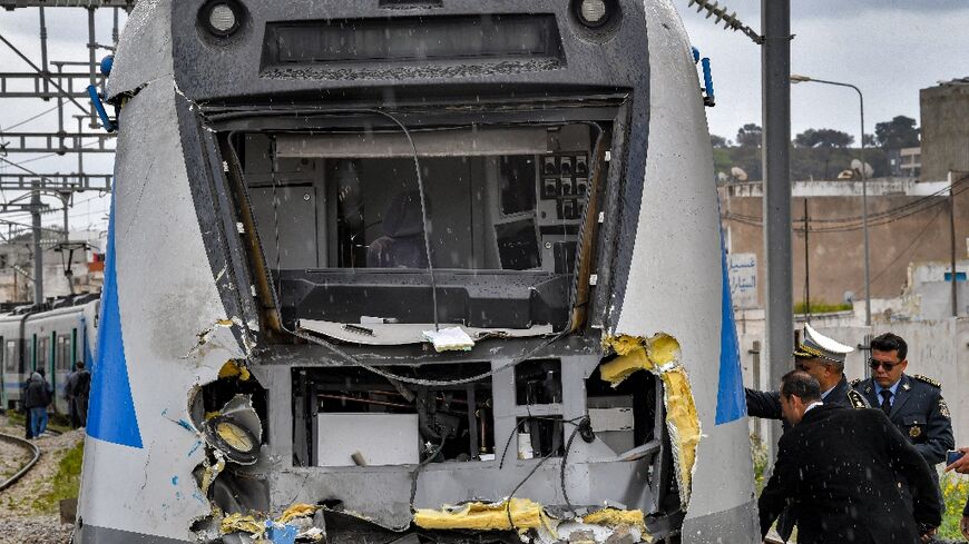 Police inspect the damage to one of the locomotives in a train collision in the Jbel Jelloud area in the south of Tunisia's capital Tunis on March 21, 2022