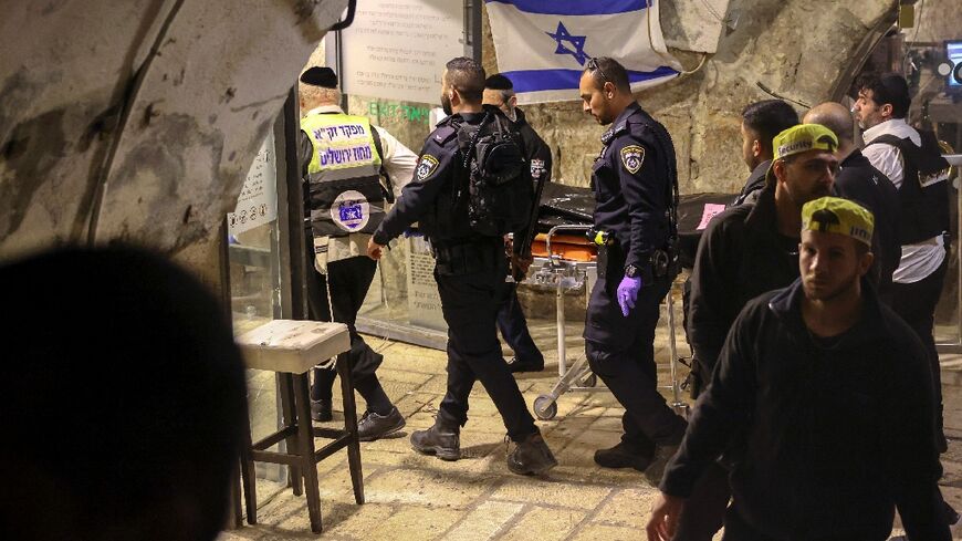 The body of a Palestinian assailant is wheeled away by Israel's ZAKA emergency and response team following the stabbing attack against police in Jerusalem's Old City, on March 7, 2022