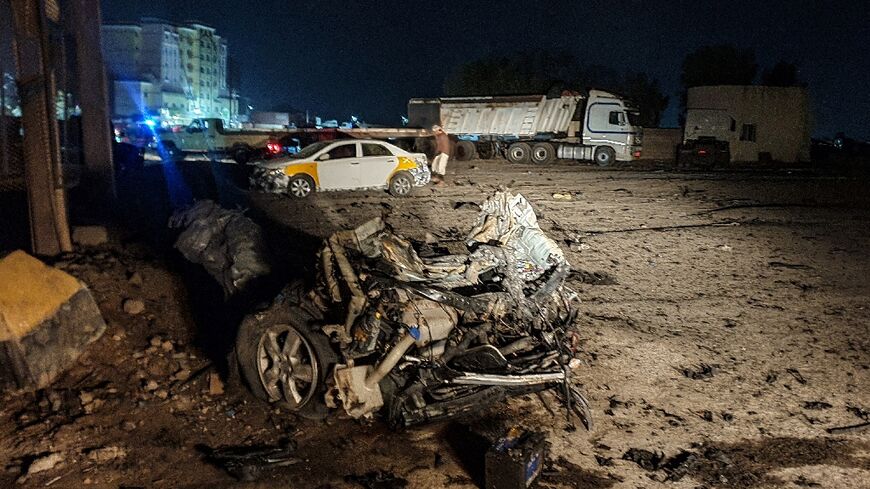 Burnt-out shell of a destroyed car lies in the area where a senior army officer was among five Yemeni soldiers killed in a bomb attack near the southern city of Aden