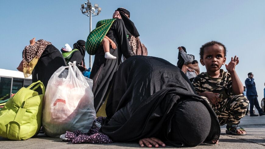 An Ethiopian woman among the happy returnees after getting off the plane in Addis Ababa