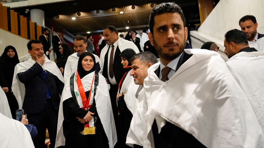 Iraqi MPs from the Sadrist bloc of Shiite leader Moqtada Sadr gather inside the Iraqi parliament in Baghdad ahead of a vote to elect a new president for the country. The election was postponed due to a lack of quorum for the second time since February