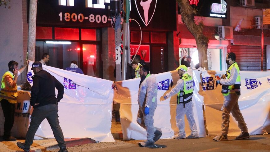 Israeli security forces gather at the site of an attack that left two Israeli police dead in the northern city of Hadera