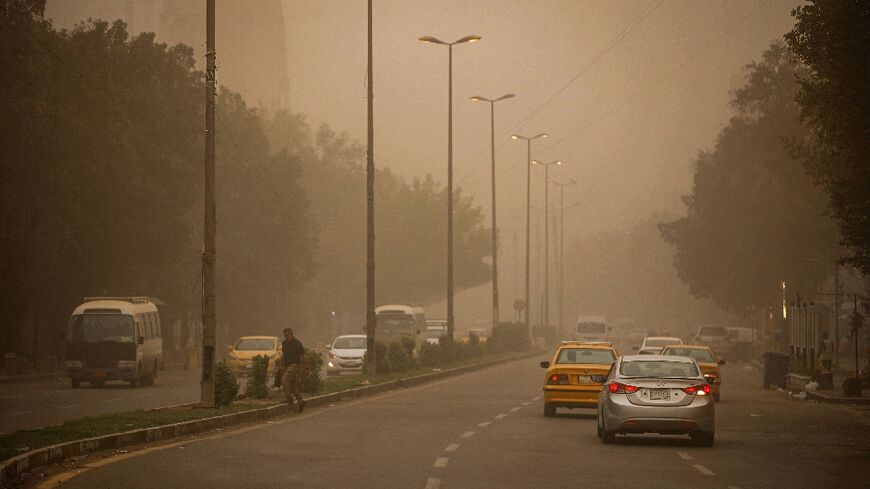 Vehicles drive through Baghdad under reduced visibility during a dust storm that engulfed much of central Iraq, the second such storm in a week