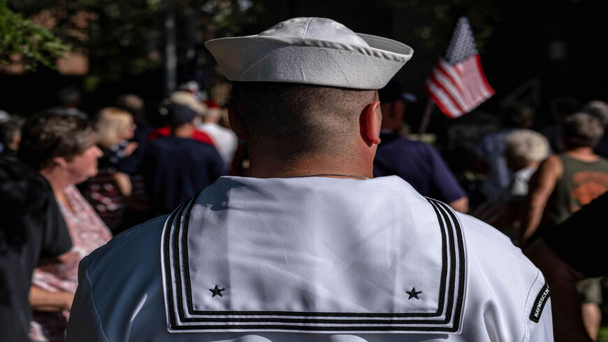 A US Navy service member attends a vigil for Navy Corpsman Maxton "Max" W. Soviak at Edison Middle School in Berlin Heights, Ohio, Aug. 29, 2021. Soviak was killed during the Aug. 26 terrorist attack outside of Kabul Airport in Afghanistan along with 12 other American service members and more than 100 Afghans.