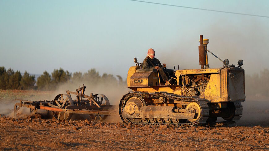 A farmer ploughs a wheat field in the countryside of the northeastern city of Qamishli, on Sept. 18, 2021. 