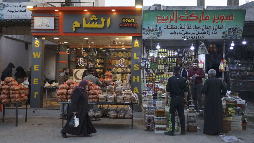 Syrians buy food supplies ahead of the Muslim month of Ramadan, at a shopping street in the northwestern rebel-held city of Idlib, on April 1, 2022.