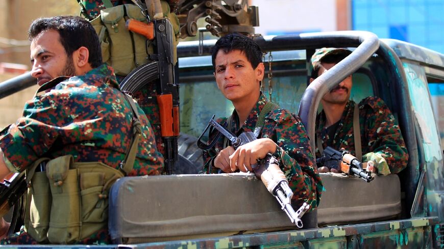 Forces loyal to Yemen's Huthi rebels take part in a military parade marking the seventh anniversary of the Saudi-led coalition's intervention in their country, in the capital Sanaa, on March 31, 2022