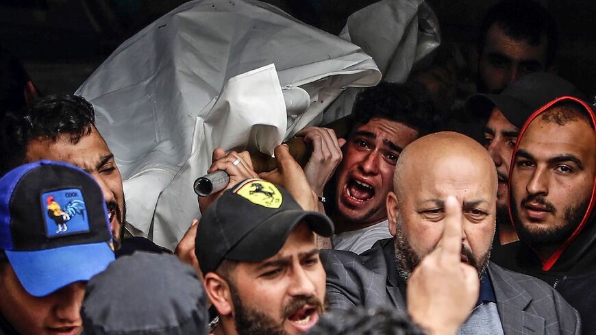 Mourners carry the corpse of one of the people who died when their boat capsized off Tripoli in northern Lebanon 