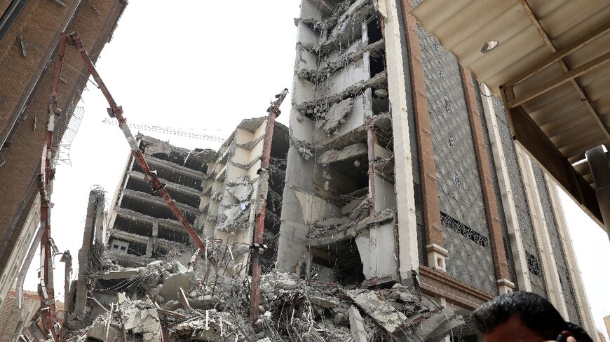 Iranians gather at the site where a high-rise building collapsed in the southwestern city of Abadan on May 23