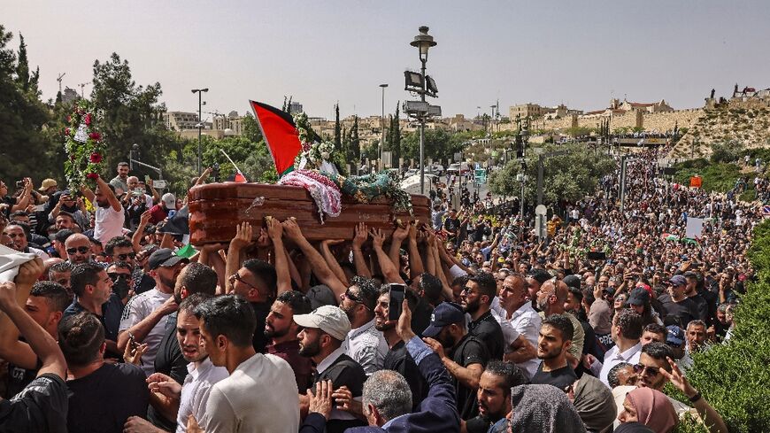 Palestinian mourners carry the casket of slain  Al Jazeera journalist Shireen Abu Akleh at her funeral in Jerusalem