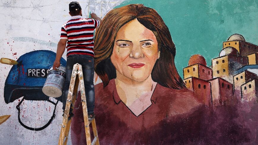 Palestinian artists paint a mural in honour of slain veteran Al Jazeera journalist Shireen Abu Akleh in Gaza City on May 12