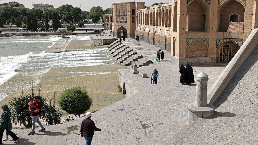 Iranians gather on the iconic Khaju Bridge over the Zayandeh Rud river in Isfahan, on May 16, 2022 