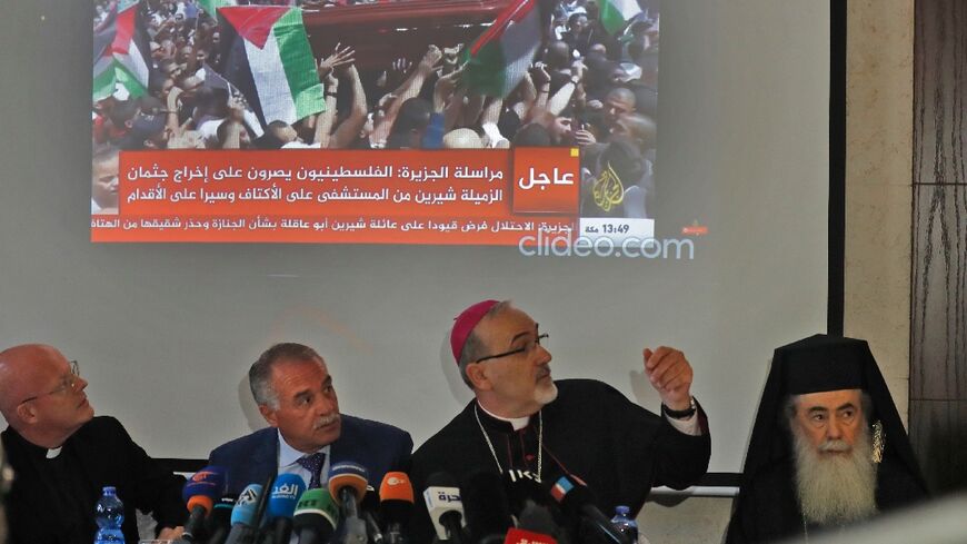 Latin Patriarch of Jerusalem Pierbattista Pizzaballa, at the centre, speaks at a press conference, joined by the Greek Orthodox Patriarch of Jerusalem Theophilos III, right, and the General Director of Saint Joseph Hospital Jamil Koussa